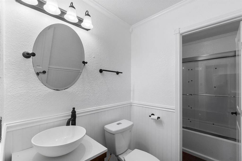 Another look at this refreshed bathroom, and you can really appreciate the details—sleek black hardware, a statement vessel sink, and a glass-enclosed tub that gives it that polished finish. Fresh, stylish, and totally move-in ready.