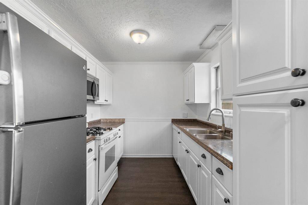 This kitchen is bringing the function and the style! Freshly painted cabinets, polished countertops, and a classic galley layout that maximizes space. Plenty of storage, a gas range for the home chef, and a window over the sink so you can enjoy the view while you prep.