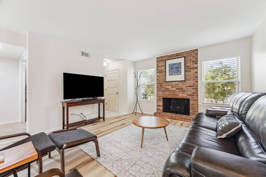 LIVING ROOM WITH UPDATED FLOORING AND WINDOWS