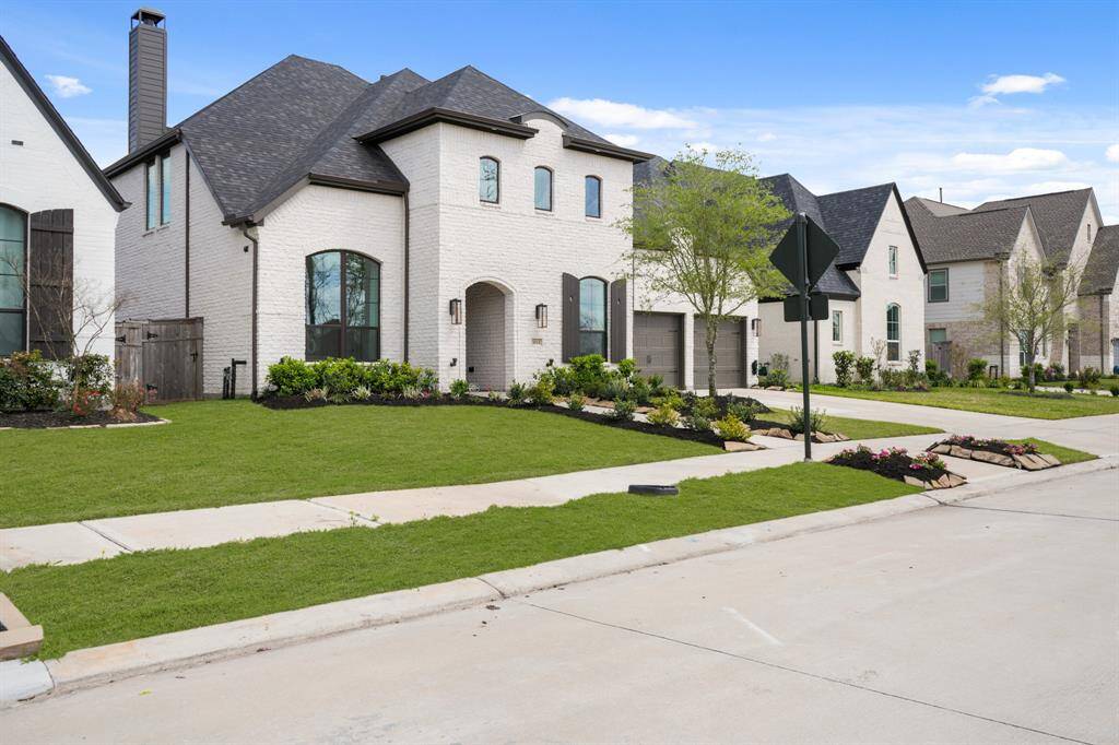 Highland Homes Plan 220 offers great curb appeal! Tumbled Artic White "Techno Brick" is low maintenance and looks gorgeous!