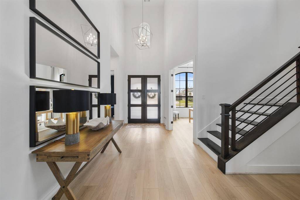 This home has such a modern vibe. The "white oak" LVP flooring withstands a houseful of kids and even pets and looks great! The oversized carriage lantern chandelier, upgraded horizontal staircase spindles and white interior paint are fabulous.