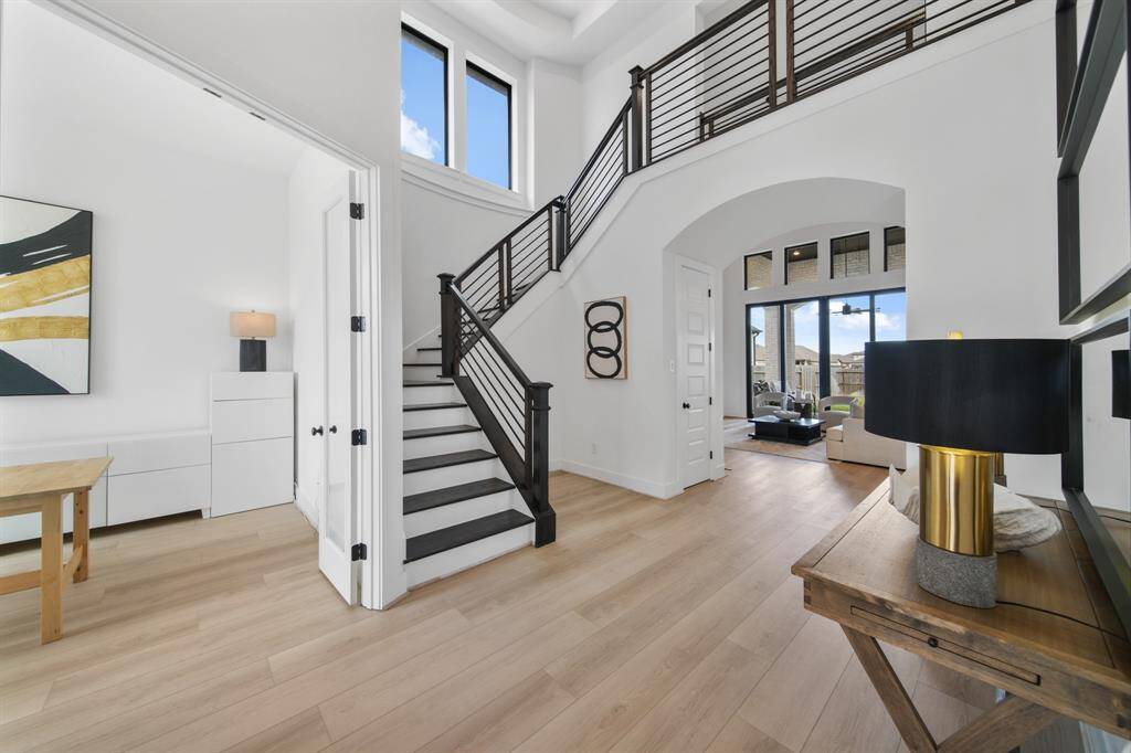 The dramatic staircase has Ebony stained treads and modern horizontal railing.
