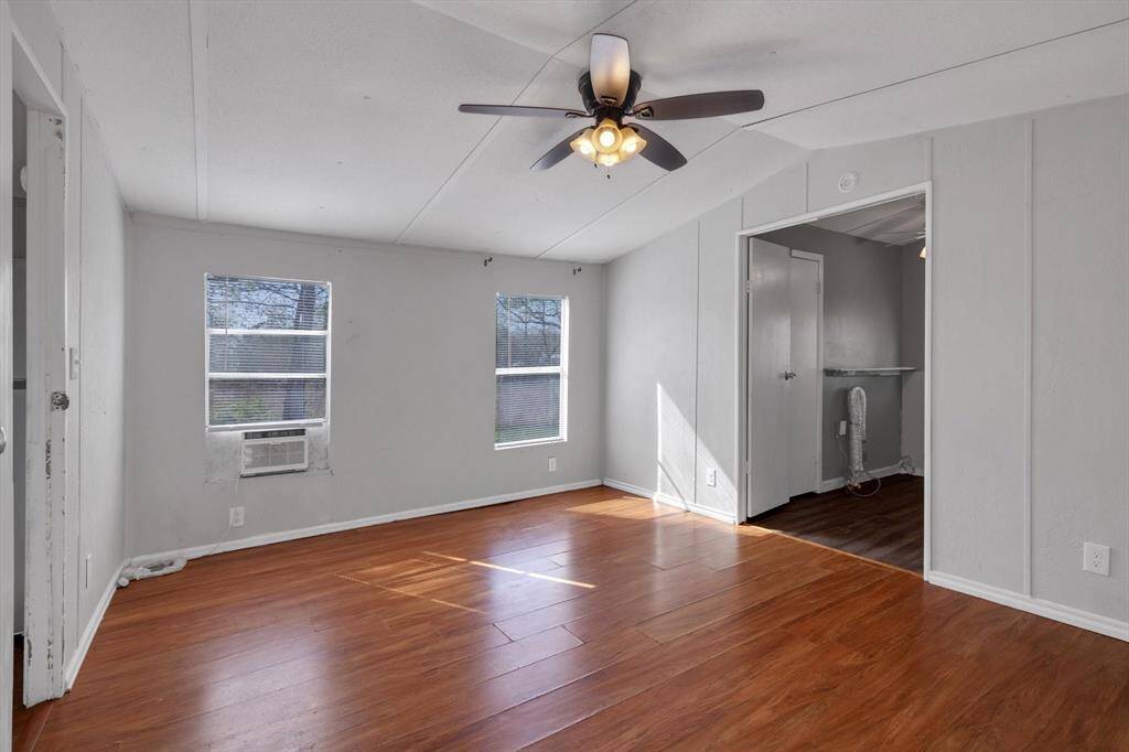 Spacious primary bedroom, abundant natural light, and a ceiling fan for comfort.