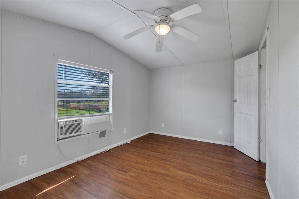 Bright and inviting, this bedroom features fresh flooring, a ceiling fan for comfort, and a window that lets in ample natural light.