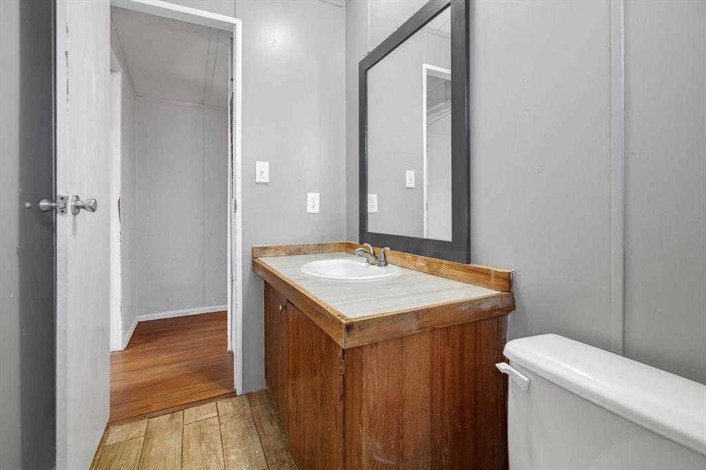 Modern and functional second bathroom featuring a sleek sink, ample counter space, and a large mirror. Perfect for guests or family use.