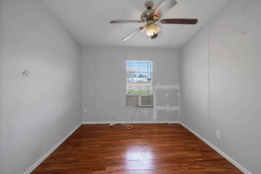 Cozy bedroom with ample natural light and a ceiling fan for comfort.