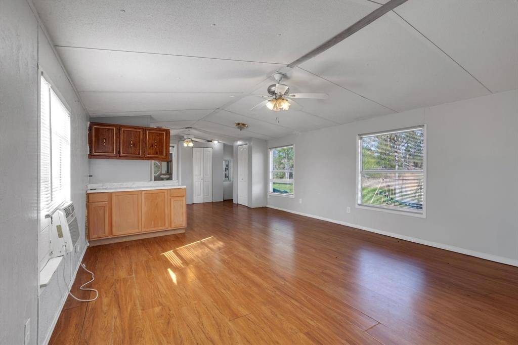 Spacious and sunlit living area, large windows, and an open layout perfect for entertaining or relaxation.