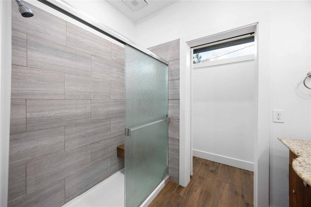 Enjoy this primary bathroom walk-in shower with a bench.