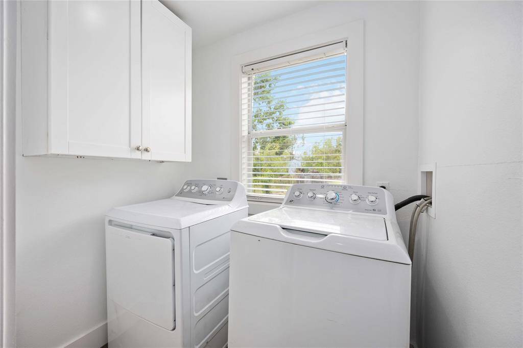 The utility room includes the washer and dryer.
