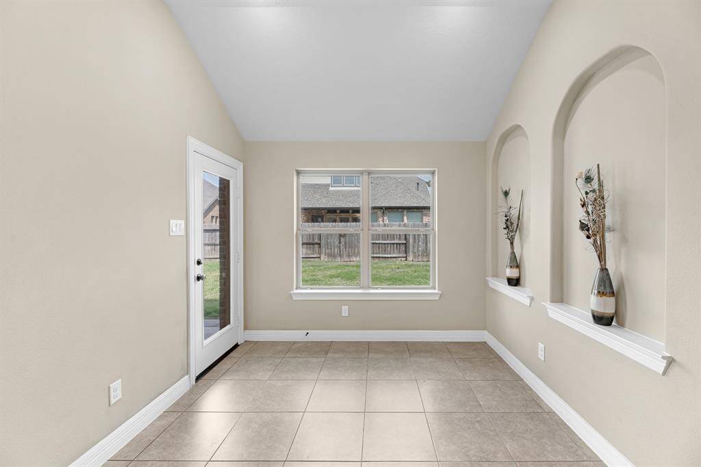 Virtual Staging of inviting breakfast area spacious enough for a charming table setting, offering views of the backyard