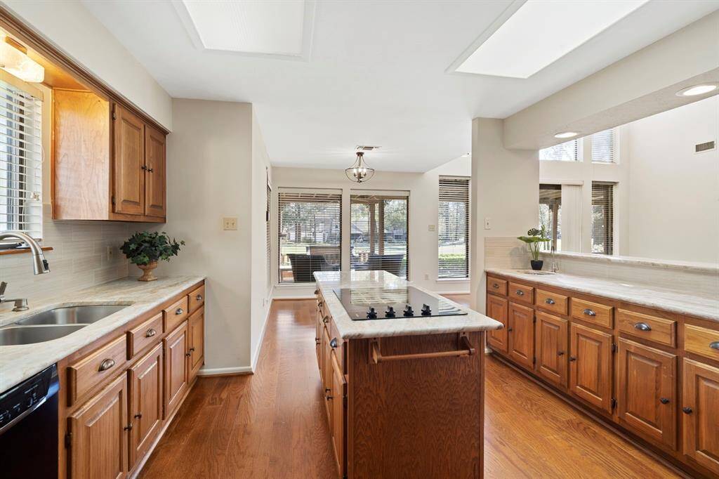 The spacious kitchen is open to the family room and features a large island, double sinks, double ovens, a pantry, and a cozy breakfast area.