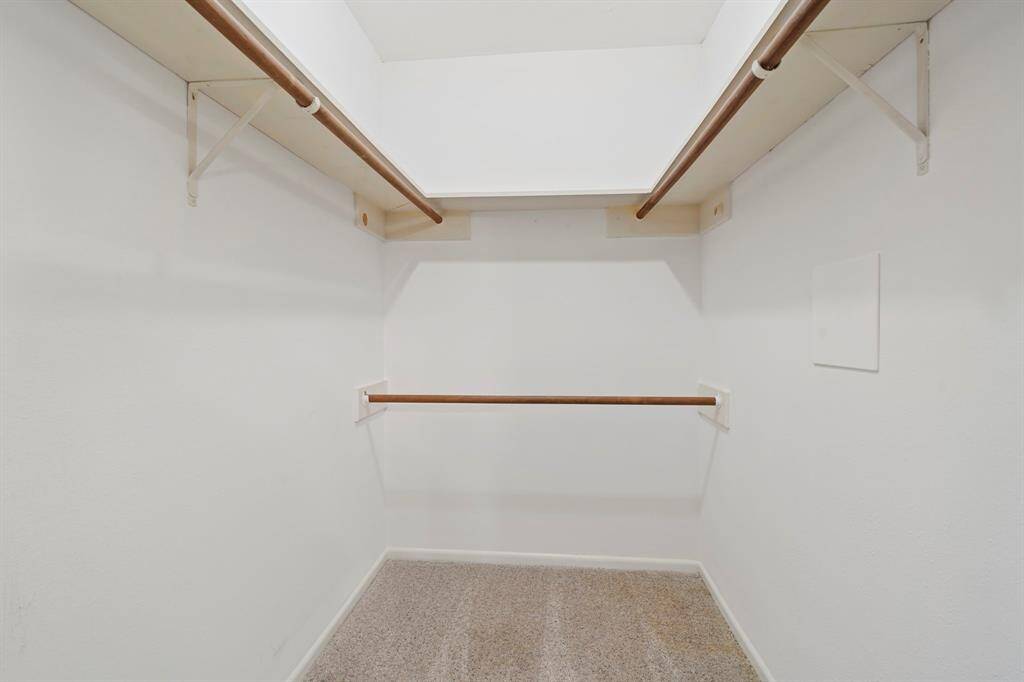 Spacious walk-in primary bedroom closet.