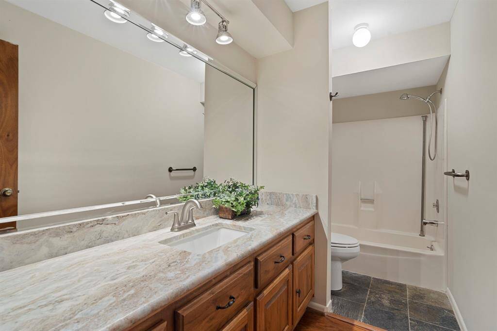 Full bathroom shared by two bedrooms, features a shower/tub combo and a large vanity providing plenty of storage. New water heater installed in 2024!