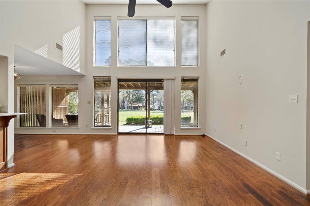 The high ceilings and large windows of this two-story great room create a sense of grandeur and openness, making the space feel larger and more airy.