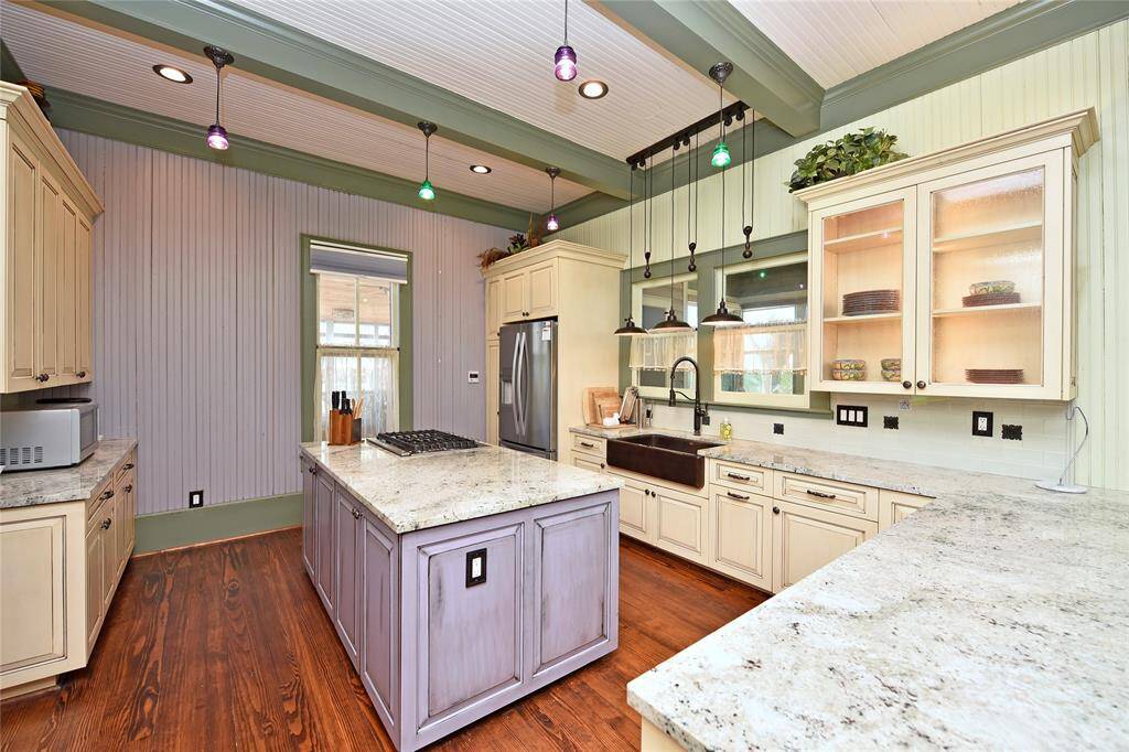 The kitchen in the main house. Granite counters, custom cabinets, apron sink, adorable lighting and comes with all you need to cook a complete meal.