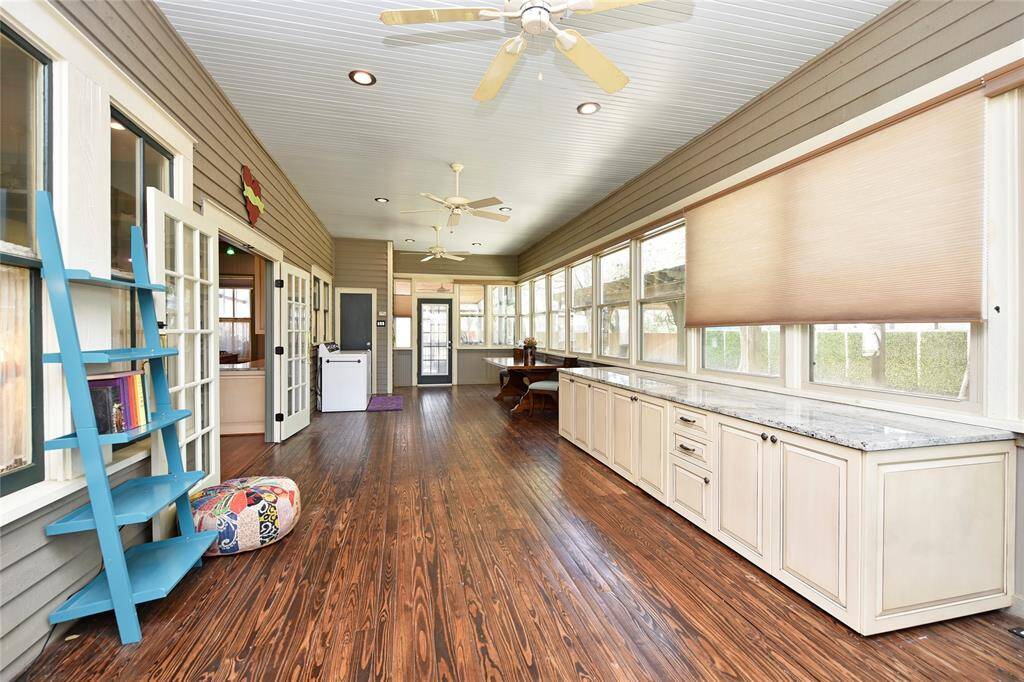 This sunroom is massive. The cabinet that is granite topped is perfect for all kinds of projects with storage galore. All thie blinds are automated. This property is very private as there is a fence all around that is gated.