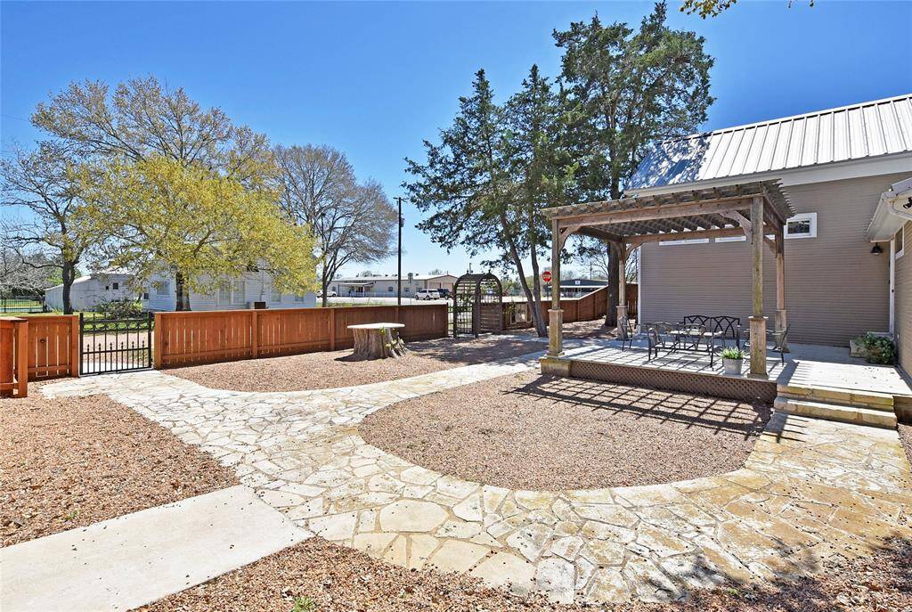 Another view of the Guest house. Notice the gates from the garage and one for guests. Don't you just love the flatwork at this property.
