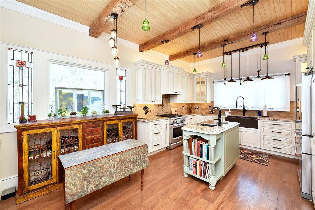 This beautiful Guest house kitchen has such unique lighting, stained glass windows and great extras.