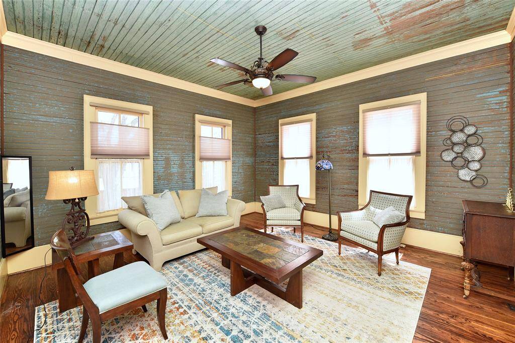 This is the formal living room in the Main home with original shiplap walls and ceilings. The patina look on the walls and ceiling are original. The owner has added top down bottom up shades for perfect lighting.
