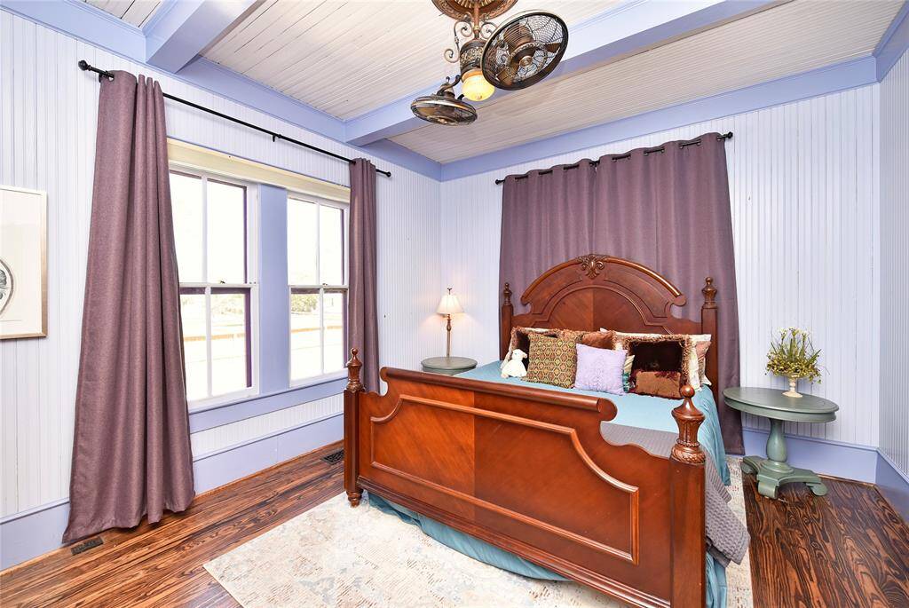The primary bedroom is a great size. The custom shades are on a remote control. The fan looks original but is newer.