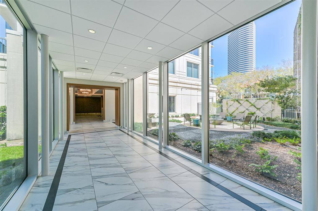 Enclosed walkway to Garage with view of patio. The firepit was removed after this photo was taken.