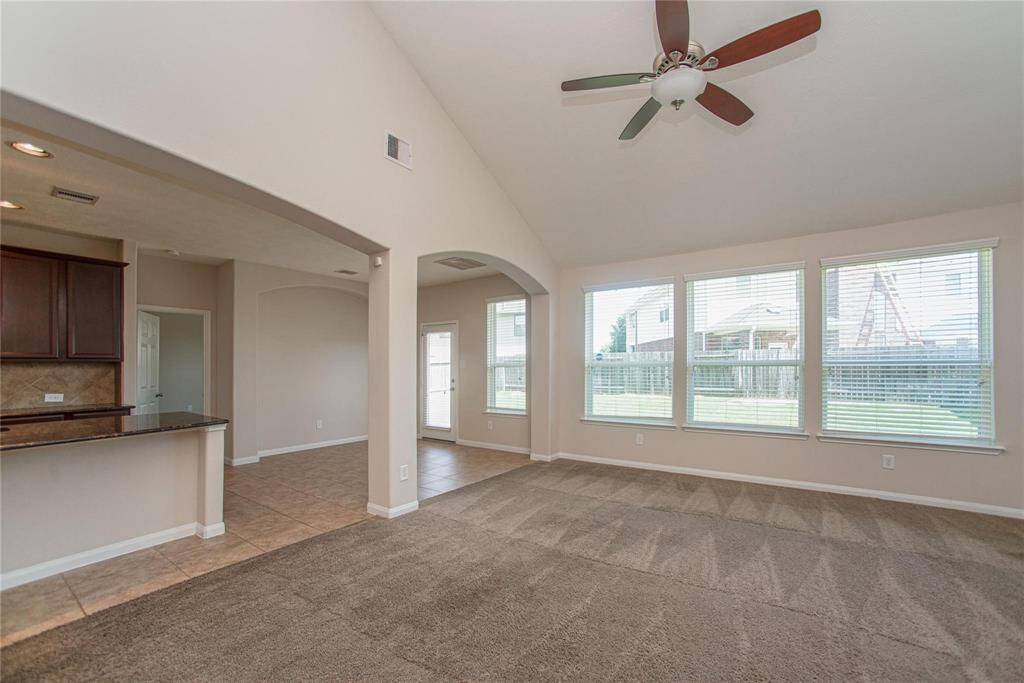 Other side of Living Room with high ceilings, tan and great views of back yard