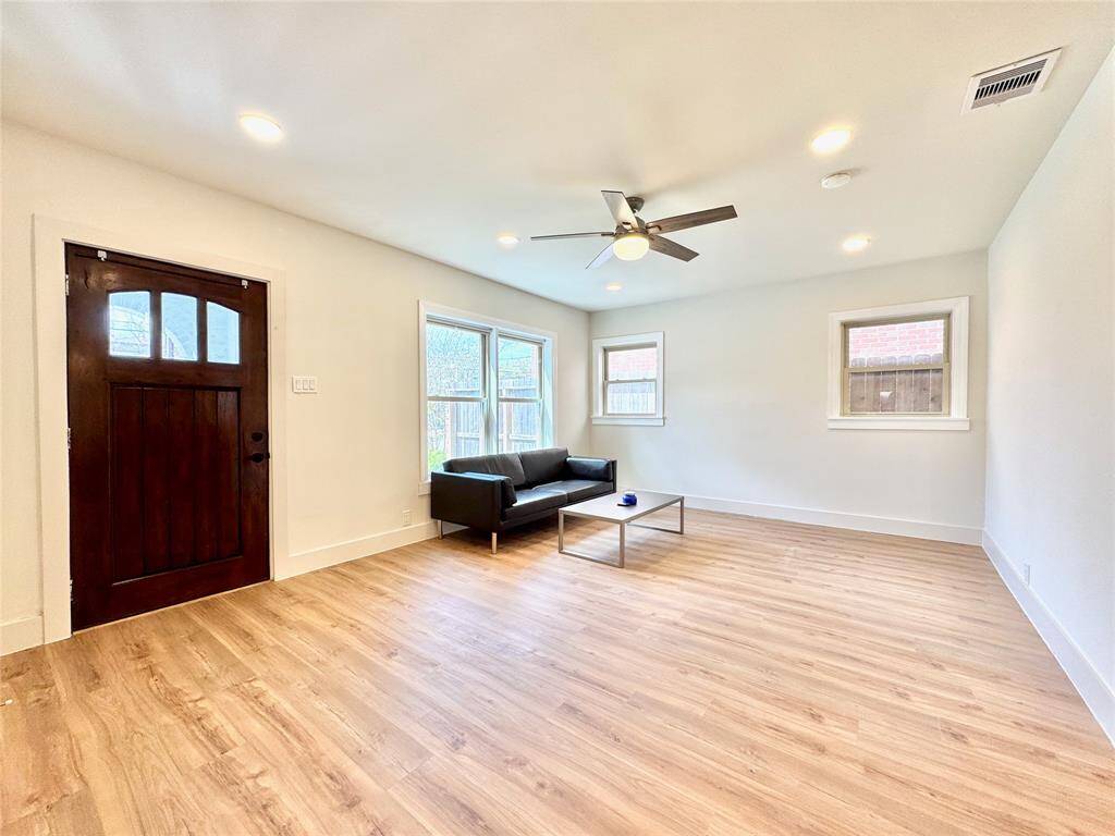 There's a front porch outside this beautifully refinished wooden door.
