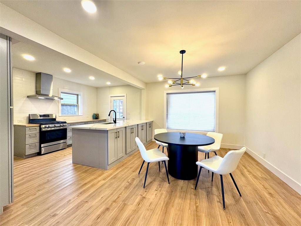 Beautifully updated dining and kitchen with lots of natural light from the oversized picture window, back door and fully operable double pane kitchen window.