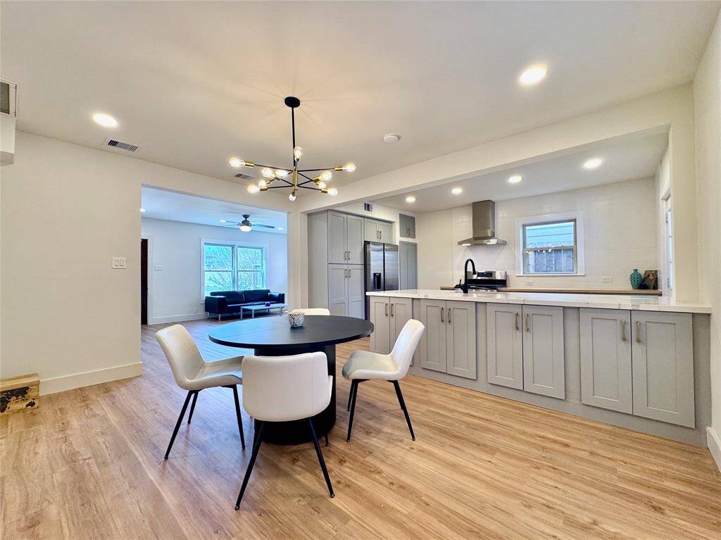 This spacious dining area offers plenty of room for a large dining set and sideboard/china cabinet. Note the extra storage cabinets under the kitchen counter.