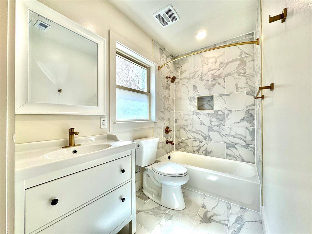 Gorgeous primary bathroom with golden hardware.