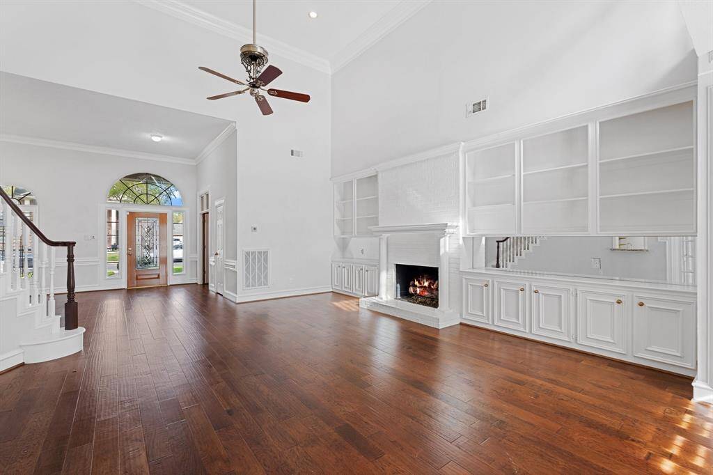 Impressive grand living room open to the second floor and well designed with amount of storage.