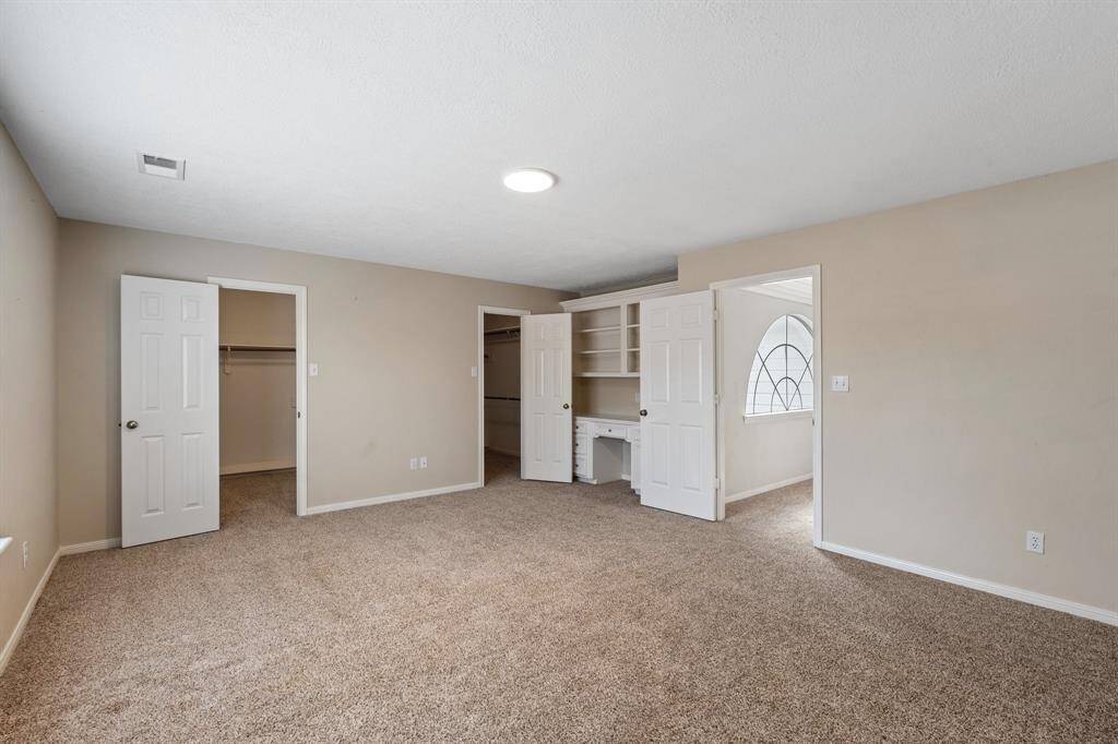 Secondary bedroom #3 has 2 walk-in closets and its own desk area, perfect for studying or storing books.