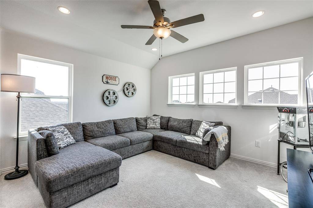 Carpeted living room with recessed lighting, baseboards, lofted ceiling, and ceiling fan
