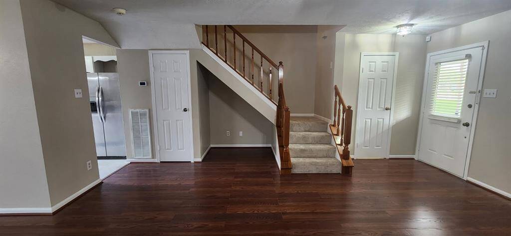 Closet door on the left of the stairs and 1/2 bath door to the right