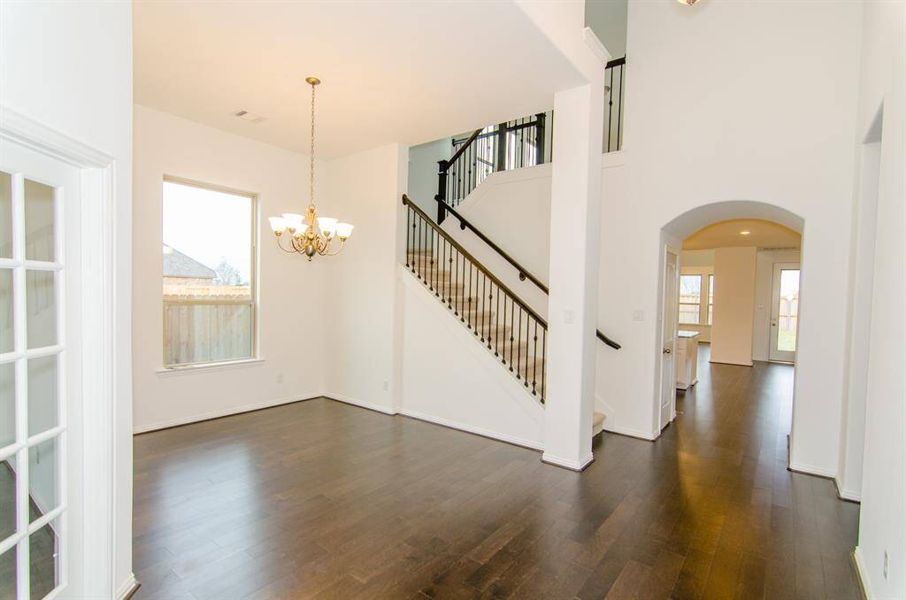 From Entrance Foyer looking in to stairs and to living room in back