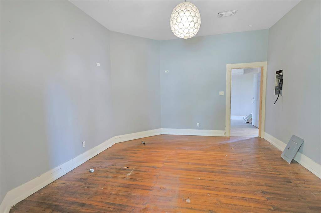 Appreciate the warmth of the wood floors and the abundance of natural light in this inviting bedroom- full of charm and potential.