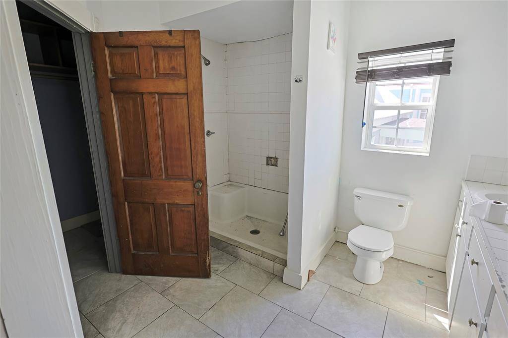 Bathroom in progress featuring a stand-up shower with built-in bench and a dedicated vanity space- ready for your design eye.