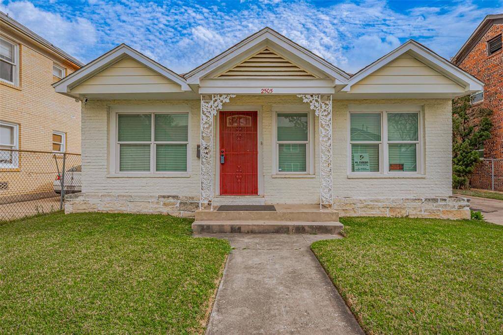 A welcoming first impression, the home's classic brick façade is complemented by a neatly maintained lawn and a central walkway leading to the entry. Its simple yet charming appeal blends warmth with versatility.