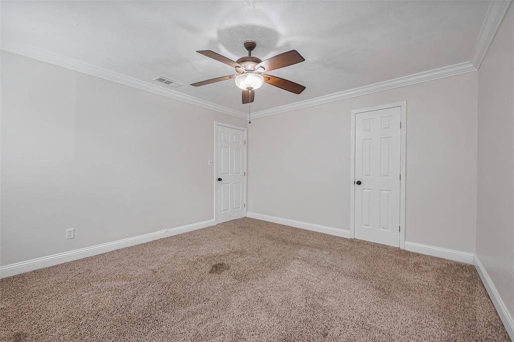 Designed for comfort, this bedroom’s neutral palette and soft carpeting create a peaceful setting.