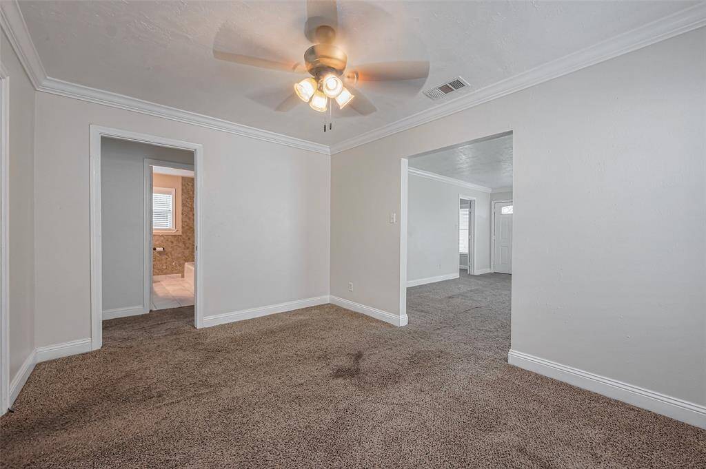 The addition of crown molding enhances this dining space, lending a touch of elegance to its simple, modern design.