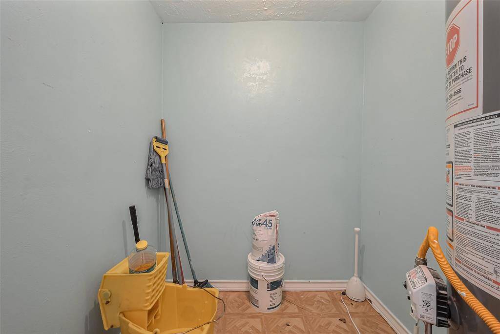A dedicated utility room provides functional space for laundry, storage, or organizational needs.