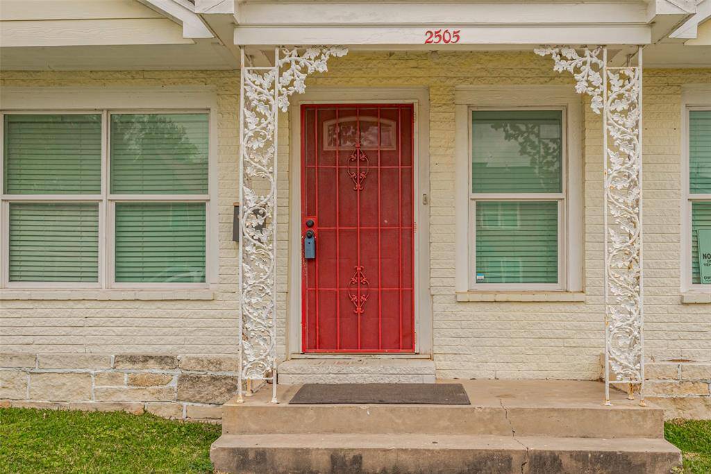A charming portico with decorative pillars frames the front door, offering architectural interest.