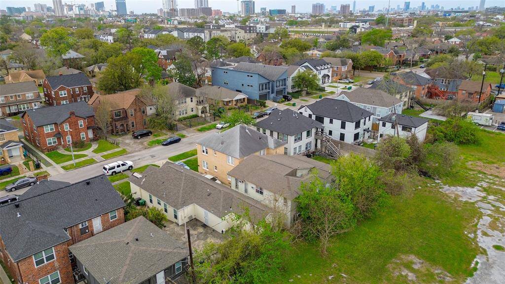 This angle reveals the backyard and nearby properties while offering a glimpse of the city skyline beyond.