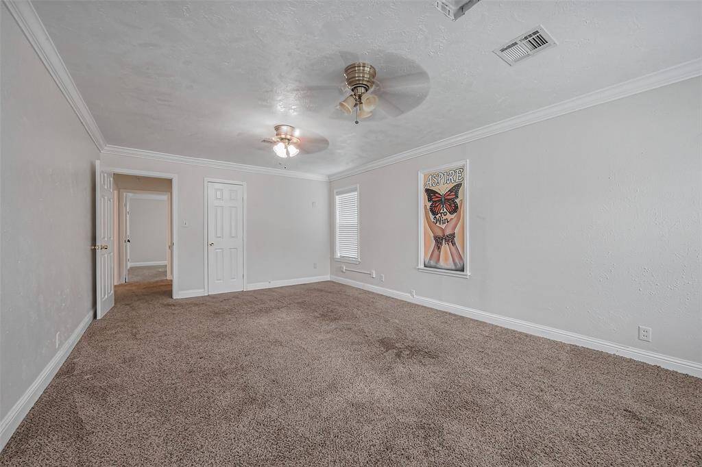 Generously sized and carpeted for comfort, this bedroom offers a restful retreat. Its neutral color scheme allows for easy personalization while maintaining a bright and airy feel.