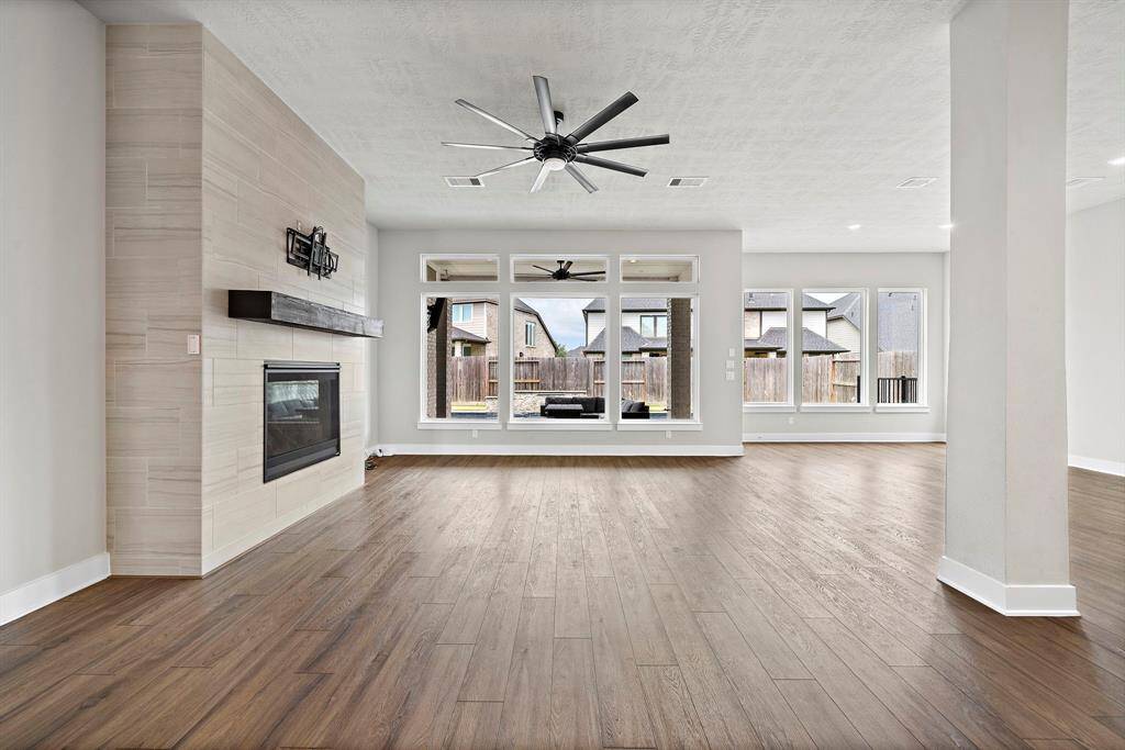 Designed for both comfort and style, this expansive space seamlessly connects to the kitchen and dining areas, making it perfect for entertaining or everyday living.