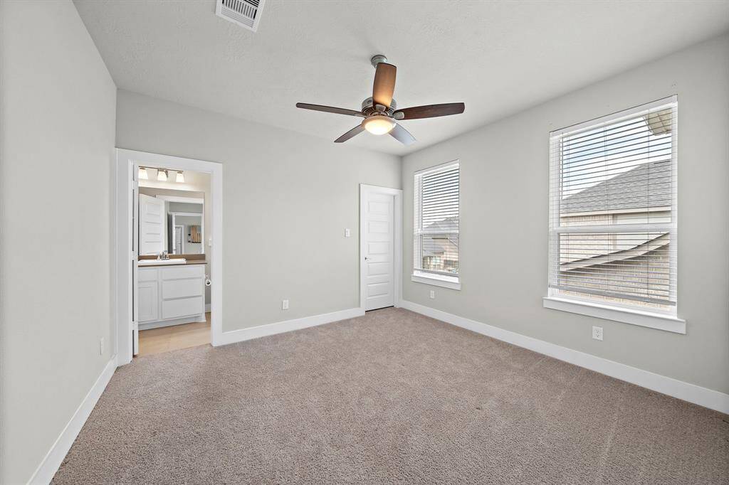 Secondary upstairs featuring its own full bathroom and walk-in closet.