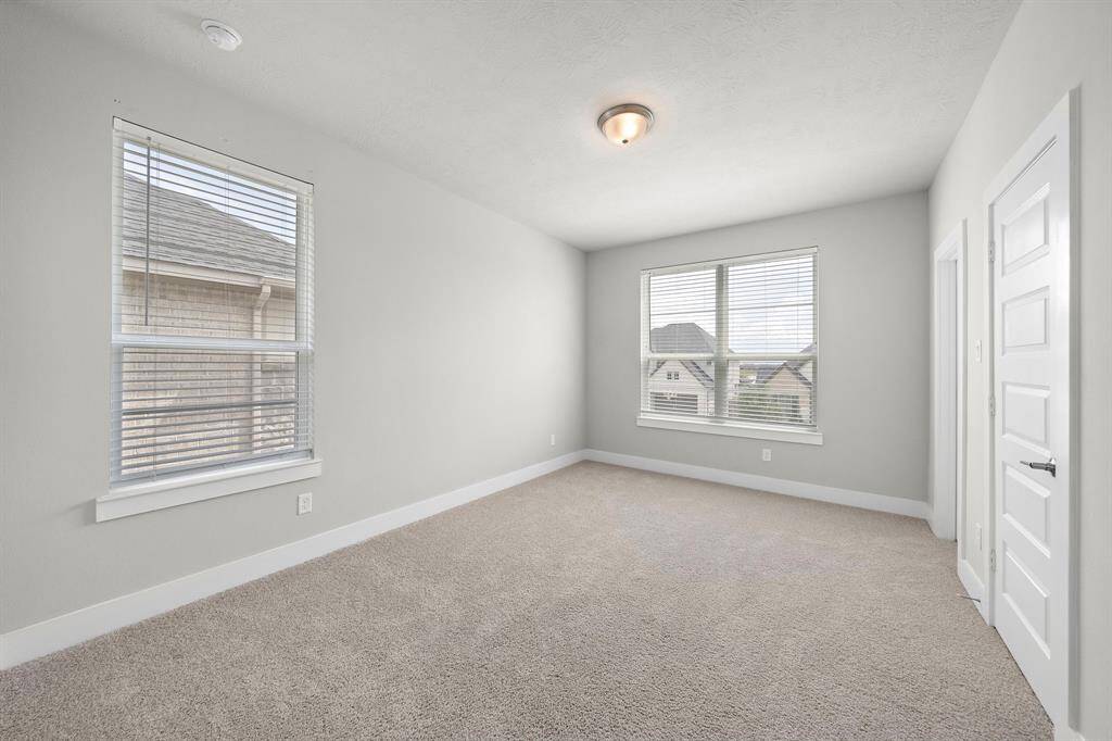 Another secondary bedroom upstairs with a walk-in closet and a jack-jill bathroom.