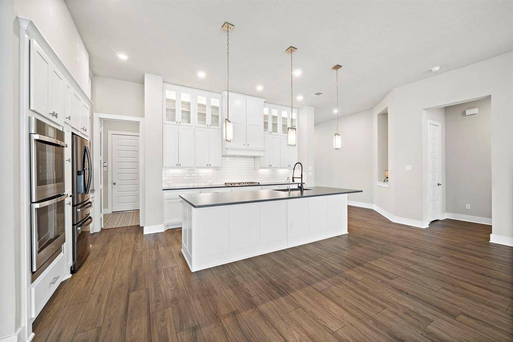 The heart of this home is its stunning open kitchen, designed for both style and functionality.