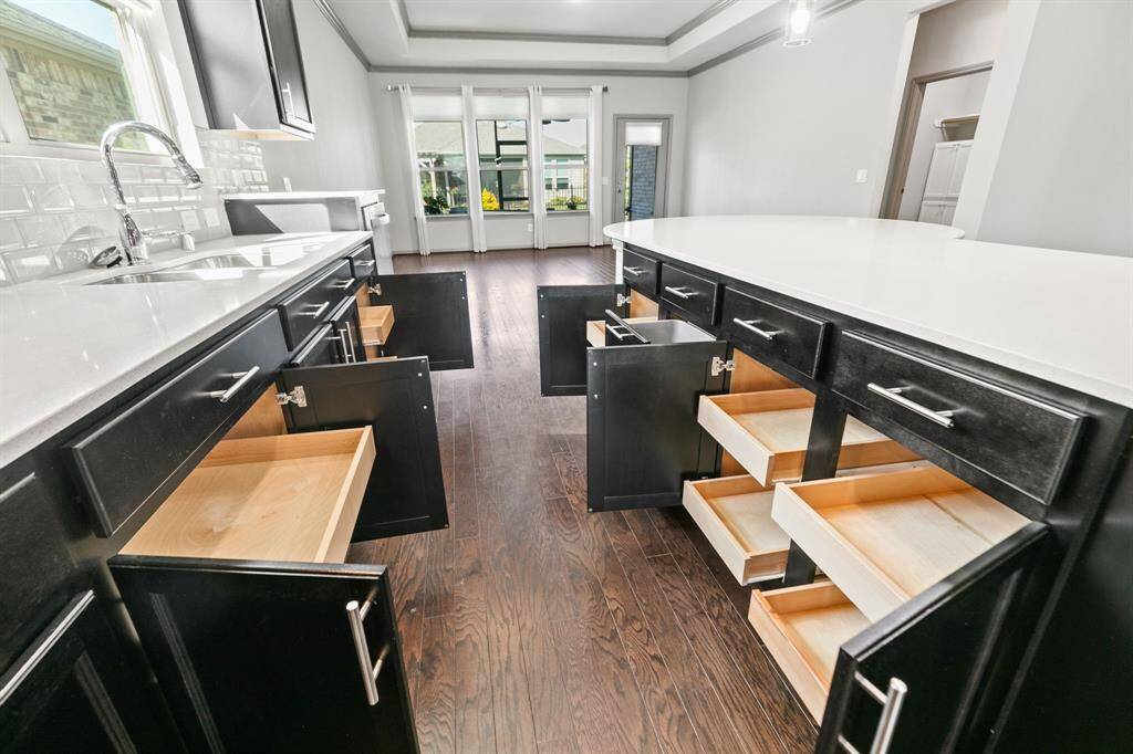 Upgraded cabinets include pull-out drawers in kitchen.