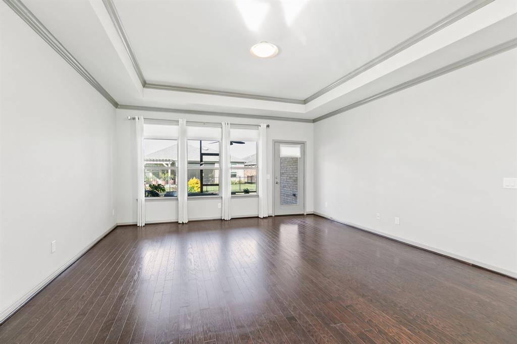 Open to the kitchen is the spacious family room with tray ceiling.